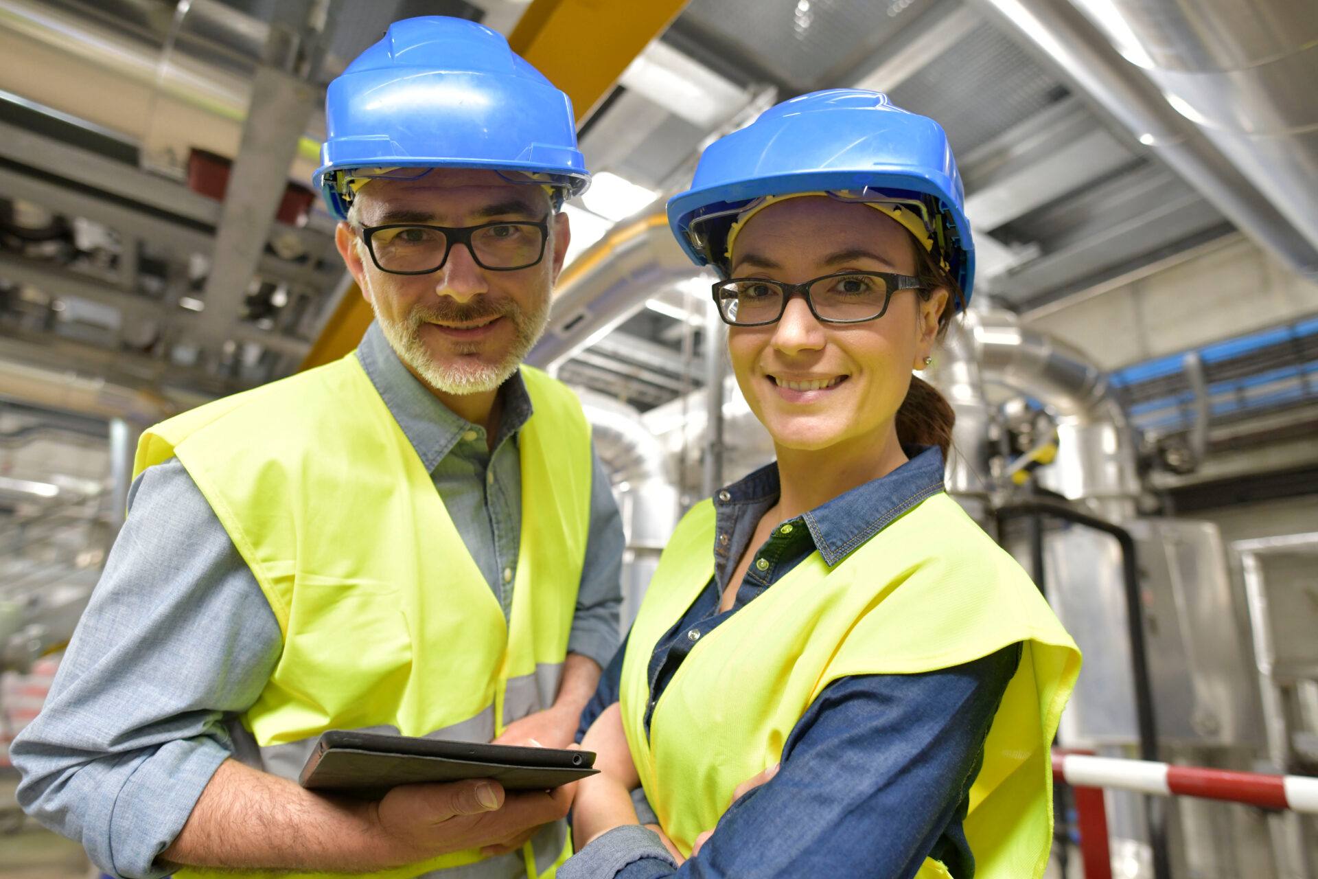 Portrait,Of,Smiling,Industrial,Engineers,Standing,In,Recycling,Plant