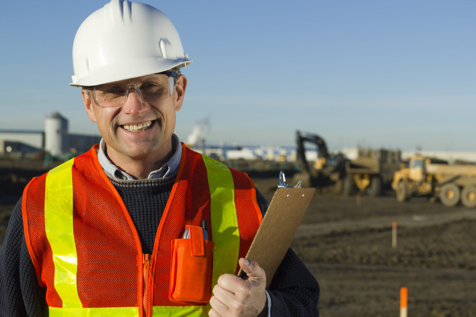 A royalty free image from the construction industry depicting an architect standing at a construction site.