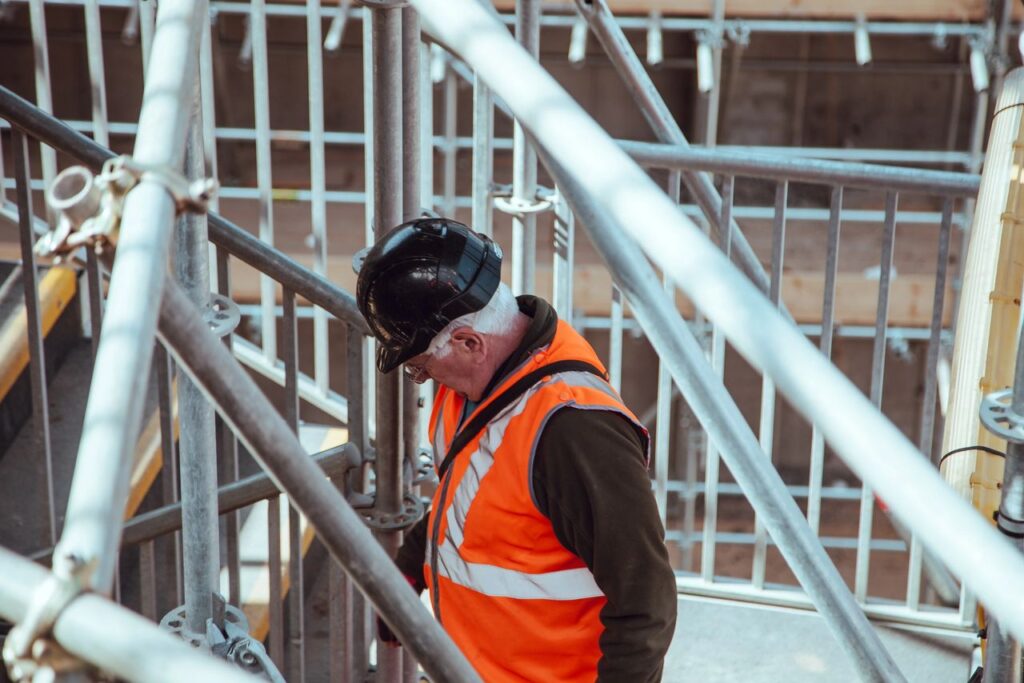 A senior construction worker carrying inspections